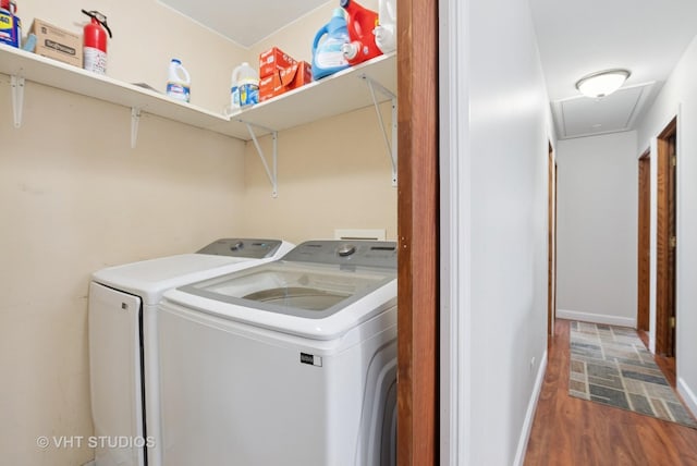 laundry area featuring laundry area, baseboards, separate washer and dryer, and wood finished floors