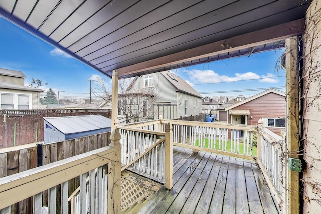 wooden deck with fence and a residential view