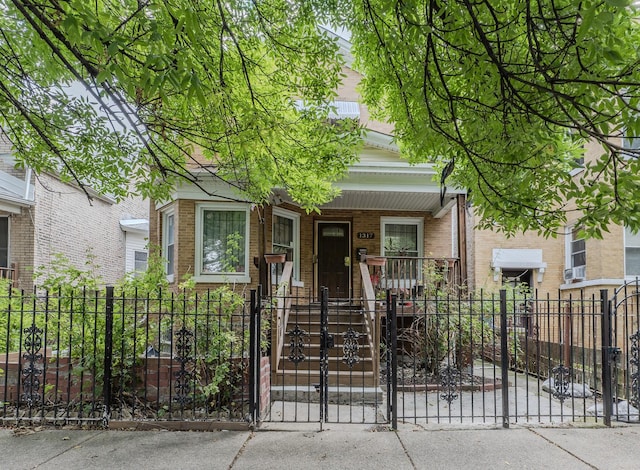 1317 N Harding Ave, Chicago, IL 60651 - view of front of house with a fenced front yard, covered porch, a gate, and brick siding