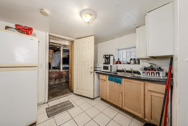 1317 N Harding Ave, Chicago, IL 60651 - kitchen featuring light tile patterned flooring, a sink, dark countertops, and white appliances