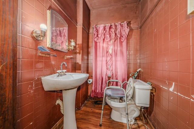 1317 N Harding Ave, Chicago, IL 60651 - bathroom featuring toilet, tile walls, and wood finished floors