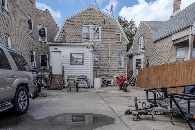 1317 N Harding Ave, Chicago, IL 60651 - back of house with a patio area, a gambrel roof, entry steps, and fence