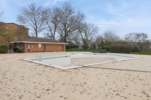 community pool featuring a patio and fence