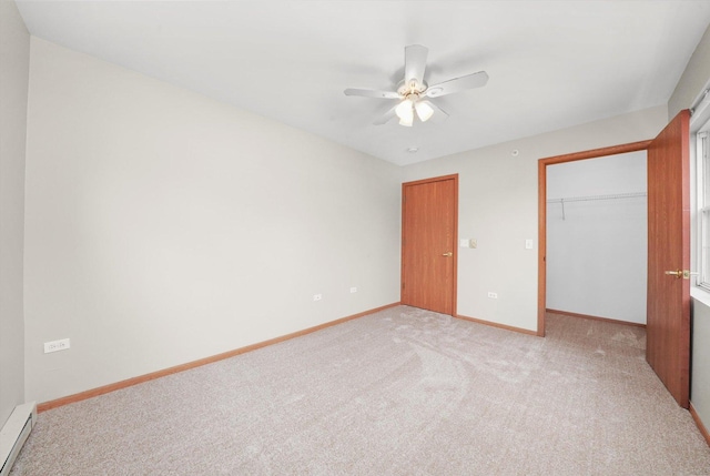 1545 W Crystal Rock Ct Unit 1B, Round Lake Beach, IL 60073 - unfurnished bedroom featuring a closet, baseboards, light carpet, a baseboard radiator, and a spacious closet