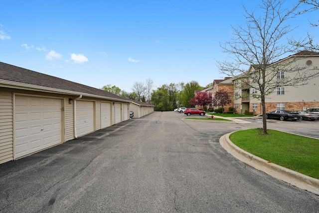 1545 W Crystal Rock Ct Unit 1B, Round Lake Beach, IL 60073 - view of road featuring community garages