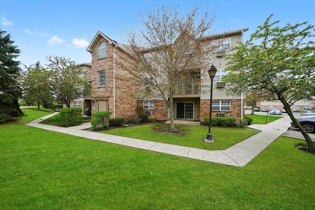 1545 W Crystal Rock Ct Unit 1B, Round Lake Beach, IL 60073 - view of front of property featuring brick siding and a front yard