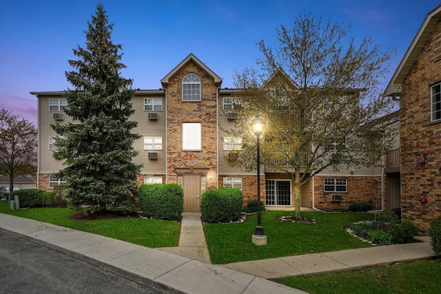 1545 W Crystal Rock Ct Unit 1B, Round Lake Beach, IL 60073 - view of front of home with brick siding and a lawn