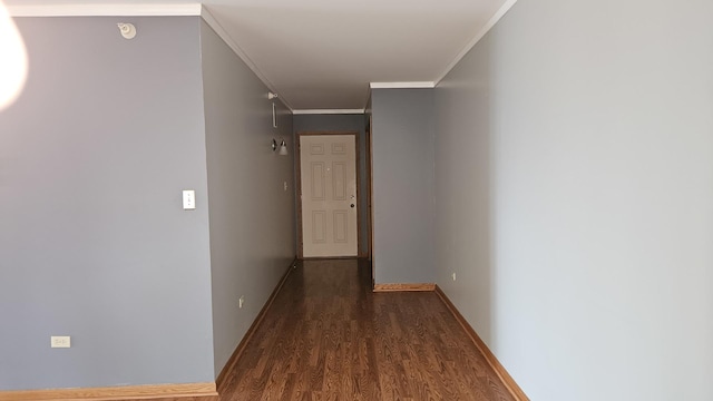 corridor featuring baseboards, crown molding, and dark wood finished floors