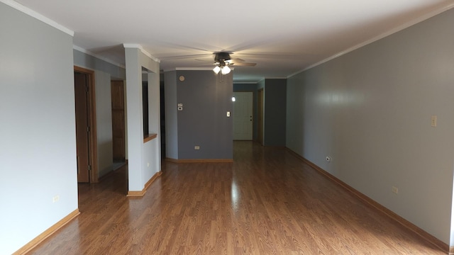 unfurnished room with ceiling fan, baseboards, crown molding, and wood finished floors