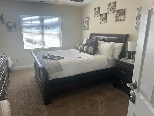 carpeted bedroom with visible vents, baseboards, and a ceiling fan