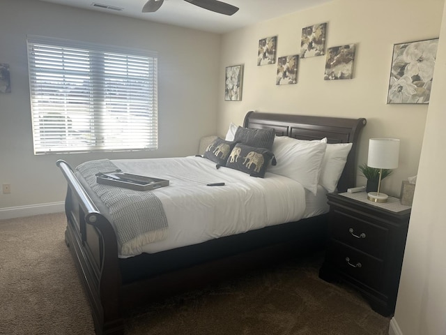 carpeted bedroom with visible vents, baseboards, and a ceiling fan