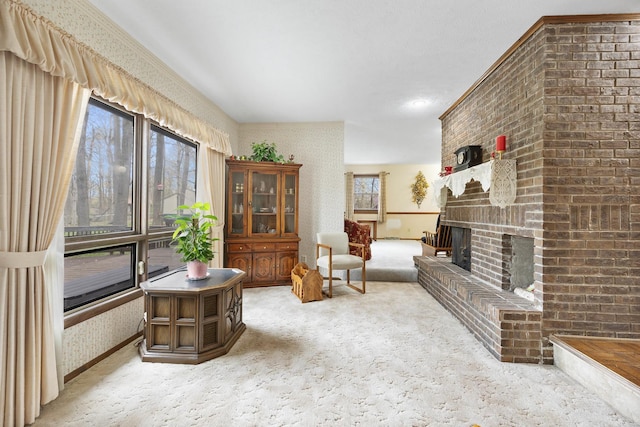 sitting room with wallpapered walls, a brick fireplace, and light carpet