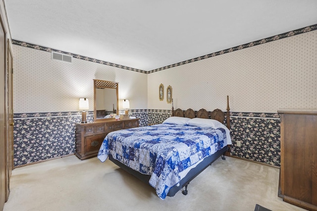 bedroom featuring wallpapered walls, carpet floors, and visible vents