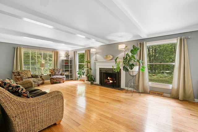 36W525 Wild Rose Rd, Saint Charles, IL 60174 - living area with beamed ceiling, a lit fireplace, plenty of natural light, and hardwood / wood-style floors