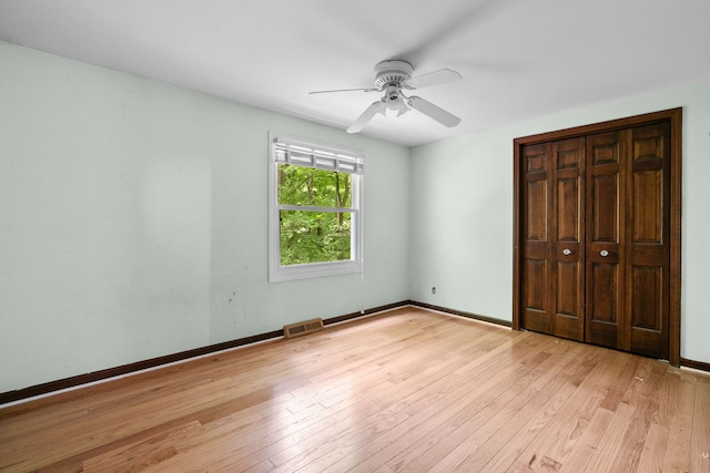36W525 Wild Rose Rd, Saint Charles, IL 60174 - unfurnished bedroom featuring light wood-type flooring, baseboards, ceiling fan, and a closet