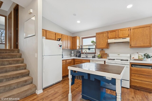 35720 N Laurel Ave, Ingleside, IL 60041 - kitchen with white appliances, under cabinet range hood, vaulted ceiling, light wood-type flooring, and light countertops