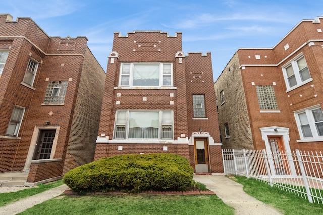 view of front of house with brick siding and fence