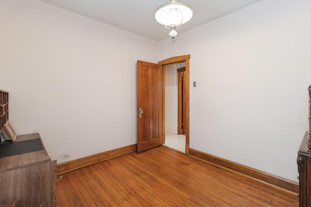 interior space featuring baseboards and light wood-type flooring