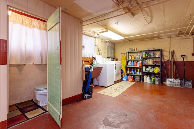 below grade area featuring washing machine and dryer and a sink