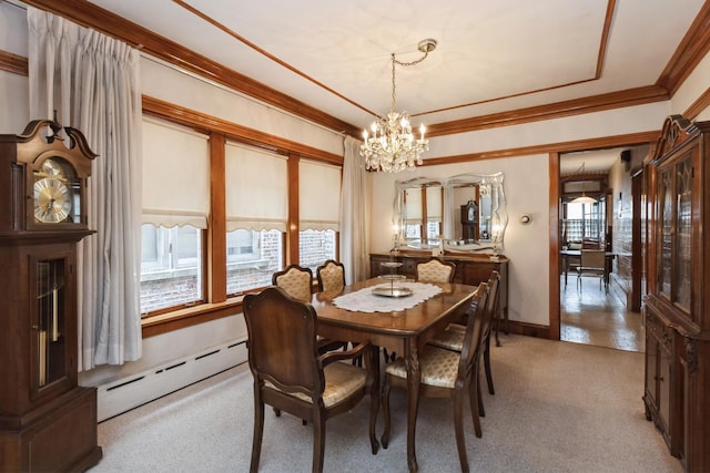 dining room featuring ornamental molding, baseboards, a chandelier, and baseboard heating