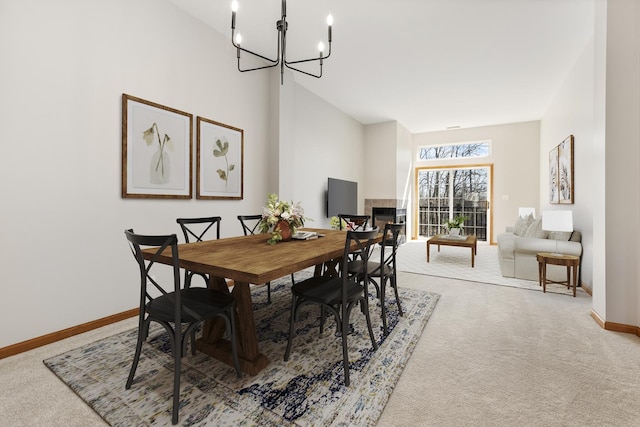 2442 Wilton Ln Unit 2442, Aurora, IL 60502 - dining area featuring a towering ceiling, baseboards, an inviting chandelier, and light colored carpet