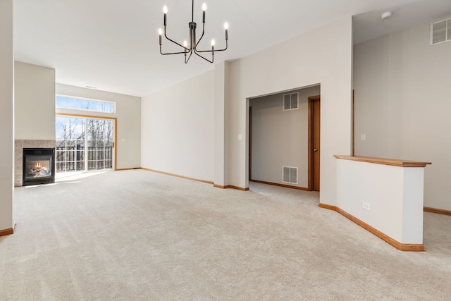 2442 Wilton Ln Unit 2442, Aurora, IL 60502 - unfurnished living room featuring a multi sided fireplace, baseboards, a notable chandelier, carpet flooring, and visible vents