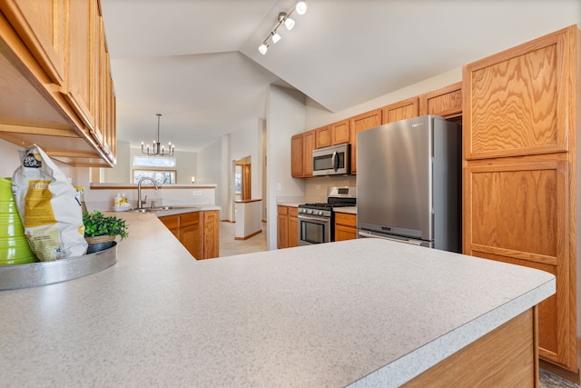 2442 Wilton Ln Unit 2442, Aurora, IL 60502 - kitchen with vaulted ceiling, an inviting chandelier, light countertops, a peninsula, and appliances with stainless steel finishes