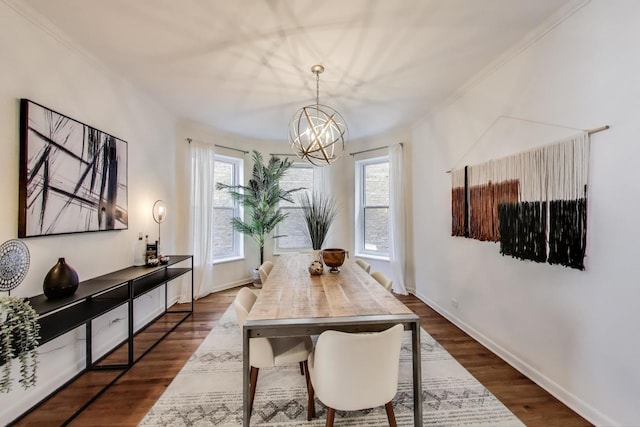 dining room with a chandelier, crown molding, dark wood-style floors, and baseboards