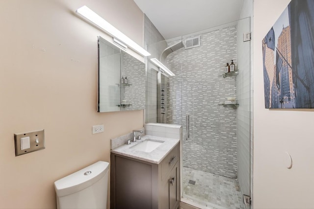 full bath featuring a shower stall, vanity, and toilet