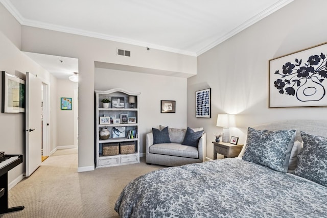 carpeted bedroom featuring crown molding and baseboards
