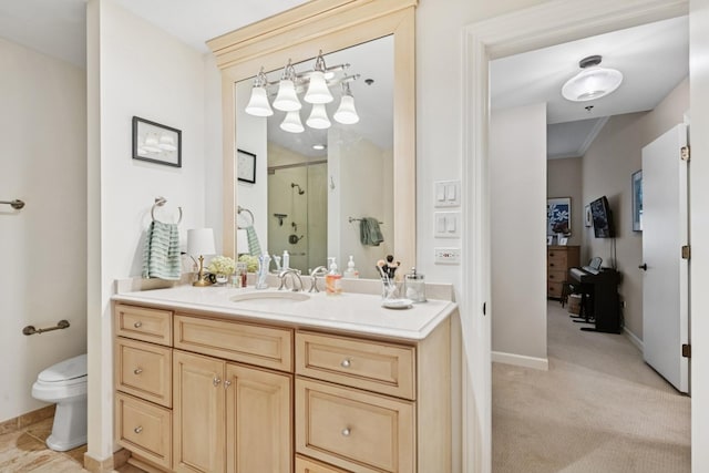 full bath with a stall shower, vanity, toilet, and baseboards