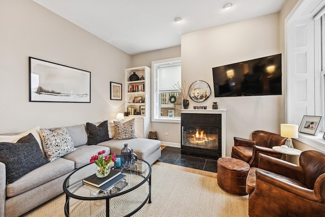 living room with a fireplace with flush hearth and recessed lighting