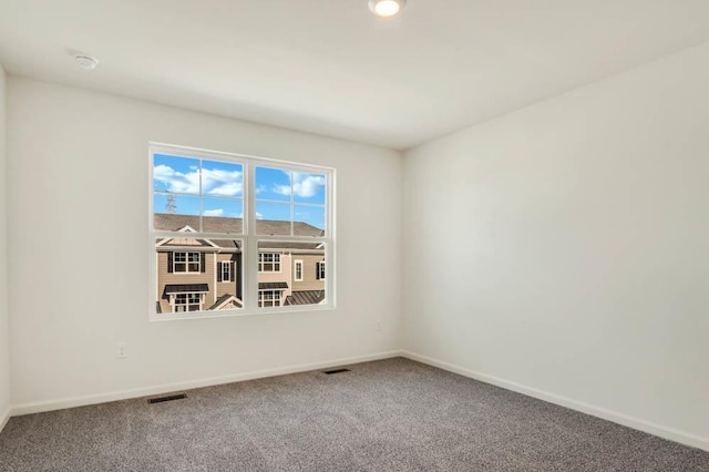 spare room with carpet and baseboards