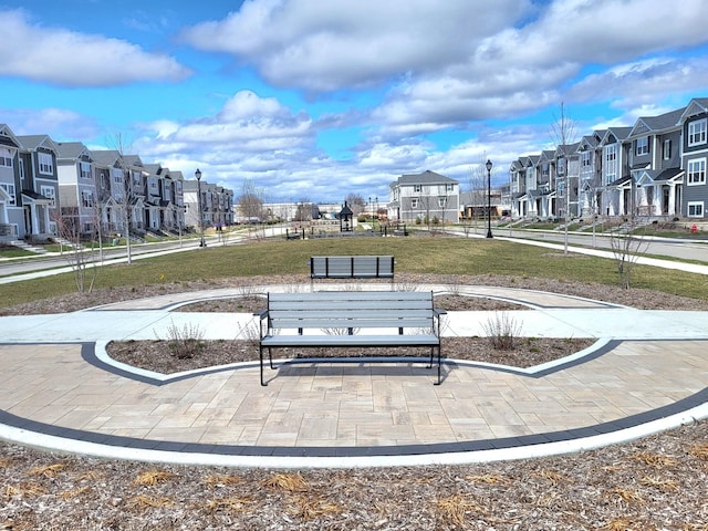 view of home's community with a residential view and a lawn
