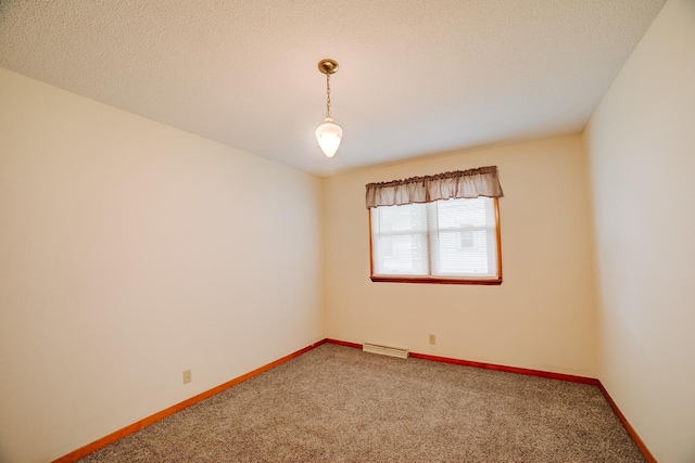 carpeted spare room featuring a textured ceiling, baseboards, and visible vents