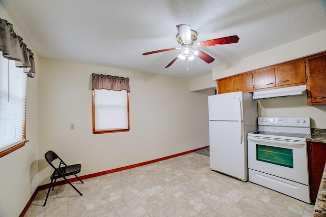 kitchen featuring white appliances, ceiling fan, under cabinet range hood, and a wealth of natural light