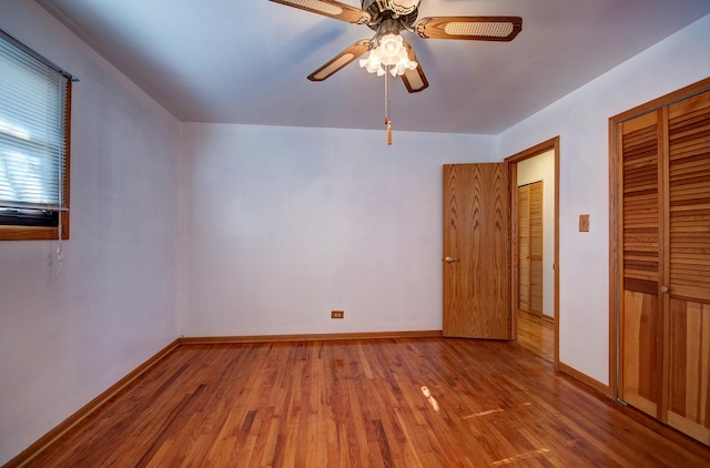 7054 Stanford Dr, Bridgeview, IL 60455 - unfurnished bedroom featuring wood finished floors, ceiling fan, a closet, and baseboards