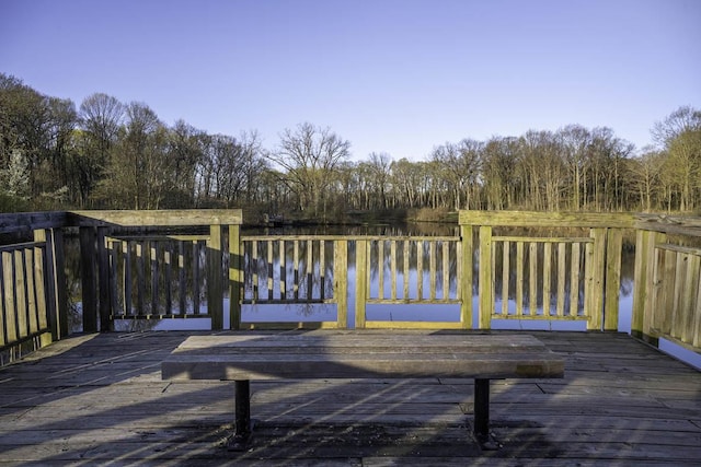 wooden terrace featuring a water view
