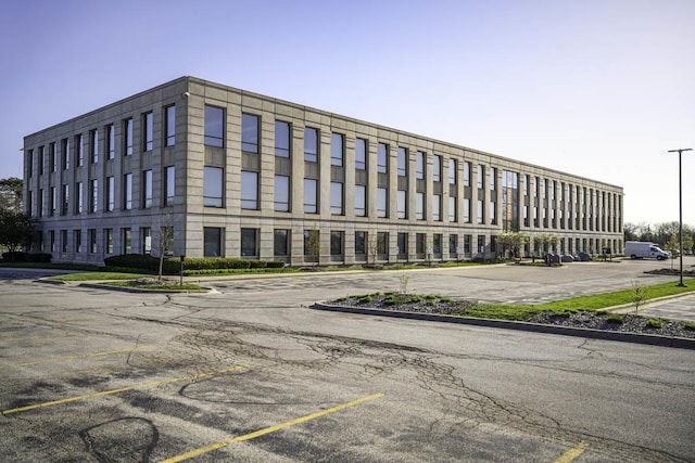 view of building exterior featuring uncovered parking