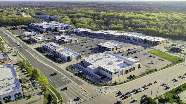 bird's eye view with a wooded view