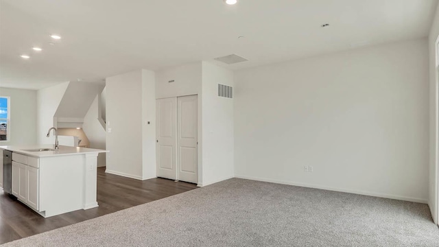 bonus room with dark carpet, visible vents, recessed lighting, a sink, and baseboards