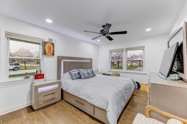bedroom featuring visible vents, multiple windows, and light wood-type flooring