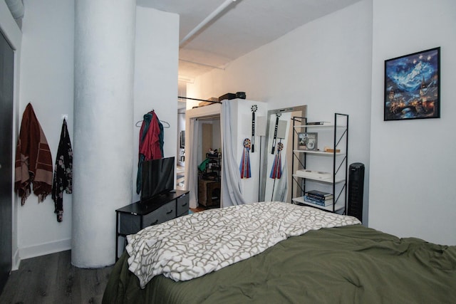 bedroom featuring baseboards and wood finished floors