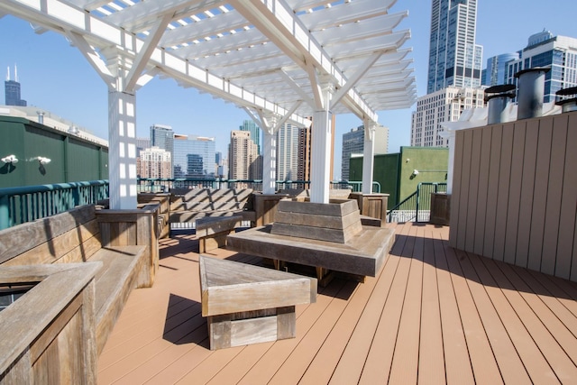 deck with a view of city, a pergola, and an outdoor hangout area
