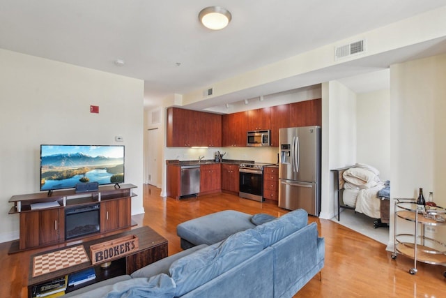 565 W Quincy St Unit 1711, Chicago, IL 60661 - living area with visible vents, track lighting, and light wood-type flooring