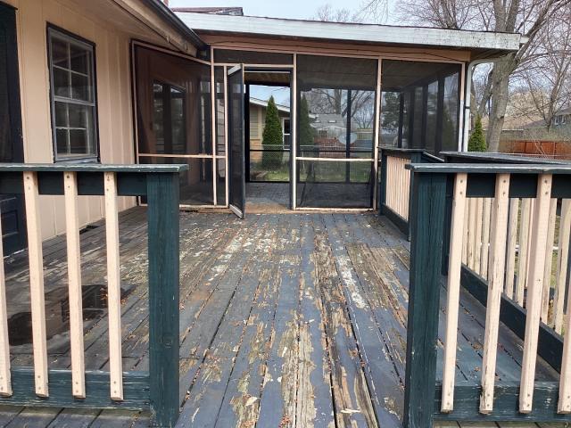 wooden terrace featuring a sunroom