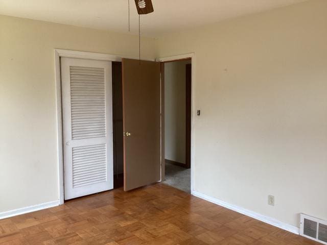 unfurnished bedroom with baseboards, visible vents, a closet, and a ceiling fan