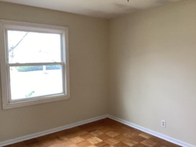 spare room featuring baseboards