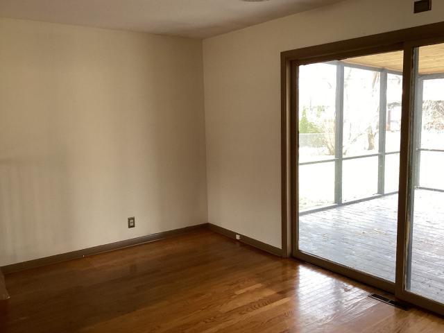 empty room with visible vents, baseboards, and wood finished floors