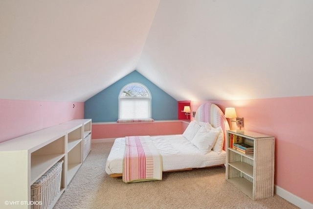carpeted bedroom with baseboards and lofted ceiling